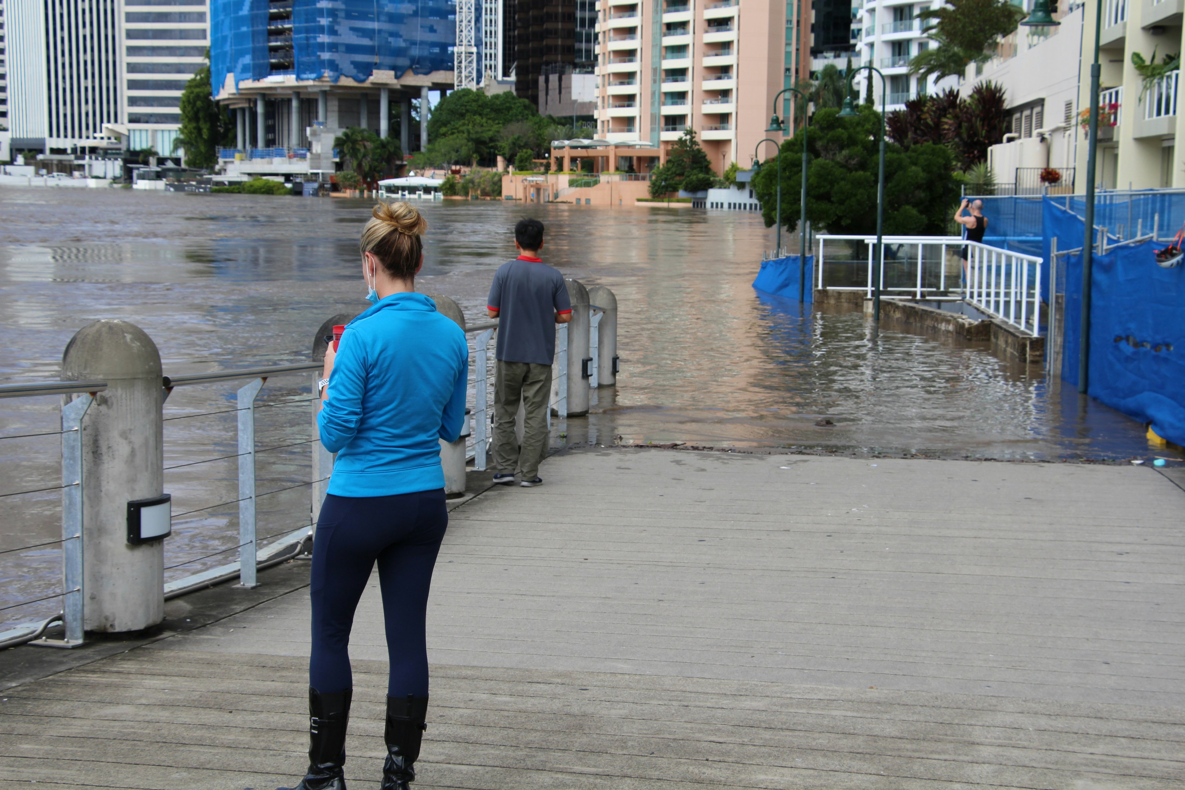 People observe flooding at the north-east of Brisbane's CBD